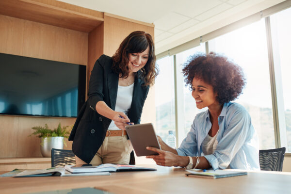 Business partners using touchscreen computer for project discuss